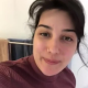 A very cute girl shits into a toilet from under her ass. A log hangs and drops with a look at the product. Filmed from a between the legs perspective. Vertical format video. Under a minute.